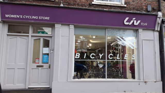 Women's cycling store with large window display featuring bicycles and "Liv York" signage above.