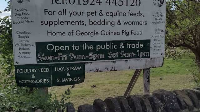 Sign for S & J Pet Supplies in Birstall, Yorkshire, listing services, contact info, and opening hours.