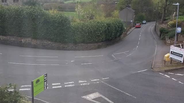 View of a quiet road intersection in Holme Valley, surrounded by greenery and a sign for "Park Side."