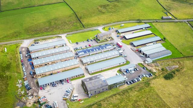 Aerial view of Craggs Country Business Park featuring multiple industrial buildings and vehicles on a green landscape.