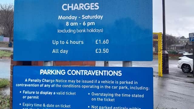 Welcome sign for Cliffe Street Car Park with parking charges and rules displayed, located in Dewsbury, Yorkshire.