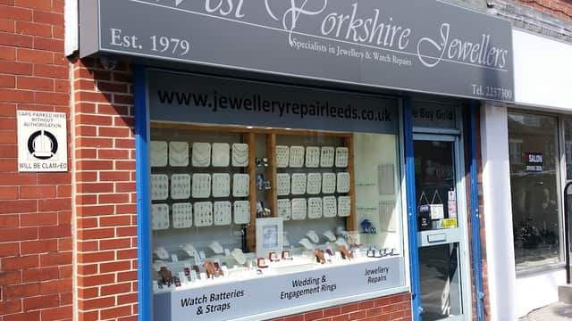 Storefront of West Yorkshire Jewellers with display cases showcasing rings, watches, and jewelry repair services.