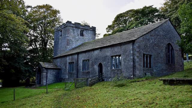 Stone church building with a tower, surrounded by trees and grassy grounds in East Marton, Yorkshire.