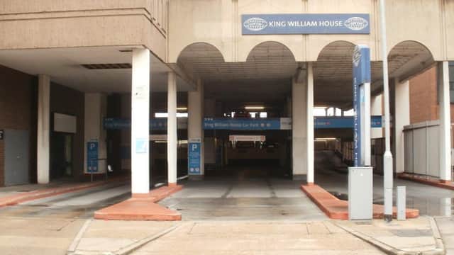 King William House car park entrance with marked parking spaces and signage in a concrete structure.