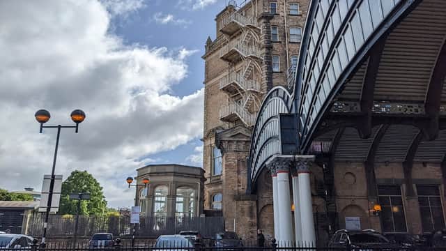 Priory Street Car Park features a historic building, a modern overpass, and parked cars under a partly cloudy sky.