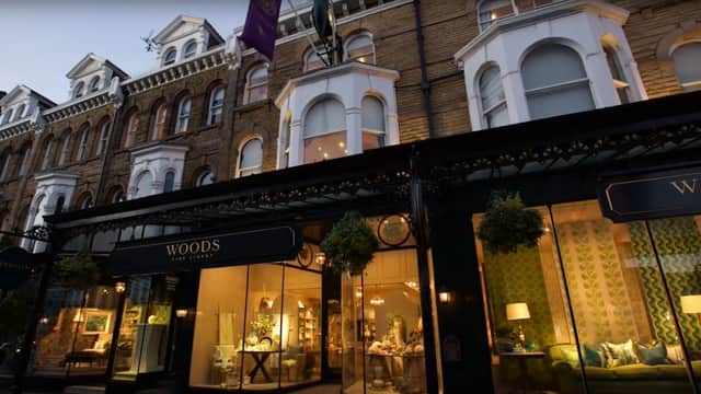 Elegant storefront of Woods Fine Linens with decorative windows, showcasing stylish home furnishings in Harrogate, Yorkshire.