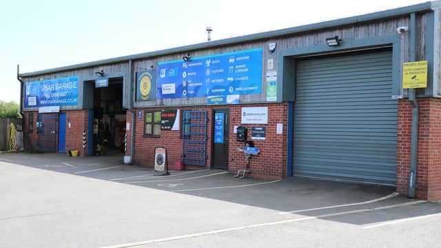 VISAR Garage with blue signage, roller door, and entrance displaying various car part services in Sowerby, North Yorkshire.