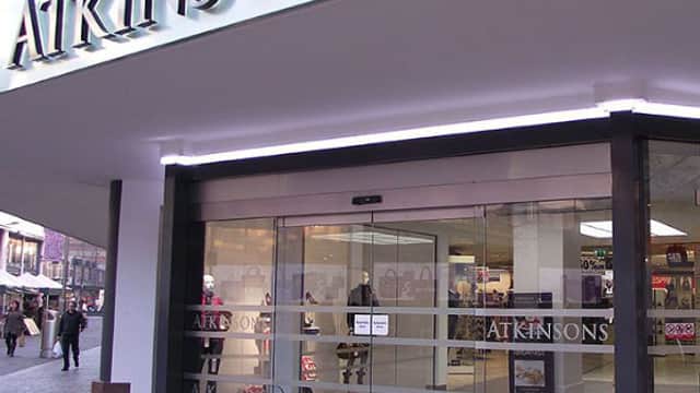 Atkinsons Department Store entrance with glass doors, modern signage, and shoppers visible outside in Sheffield, Yorkshire.