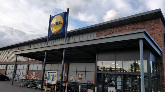 Lidl store entrance in Thirsk, Yorkshire, featuring a large sign and shopping carts outside.