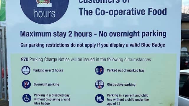 Sign for COOP Car Park in Mirfield, Yorkshire, detailing parking rules, charges, and conditions for Blue Badge holders.