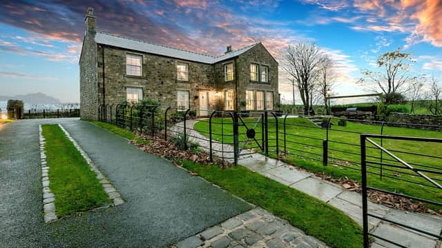 Wigglesworth House features stone architecture, a manicured garden, and a scenic sky at dusk in Wrigglesworth, Yorkshire.