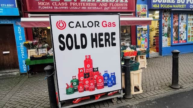 J & D Marsay Flowers storefront with a sign stating "CALOR Gas SOLD HERE" and colorful flower displays outside.