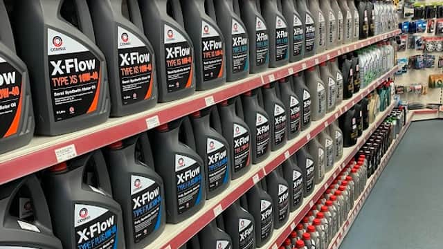 Shelves filled with various motor oils and automotive products at Maxwize Motor Factors in Bradford, Yorkshire.