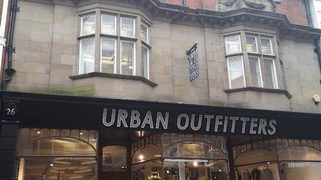 Urban Outfitters storefront with large windows, displaying clothing and accessories, in a historic building in York.