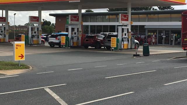 York Road Garage in Escrick, featuring a Shell station with fuel pumps, cars, and a convenience store.