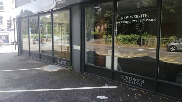 Tiago Jewellery storefront with large windows, showcasing signage for a new website and customer parking.