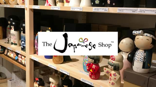 Shelves filled with colorful Japanese dolls and figurines at The Japanese Shop in Harrogate, Yorkshire.