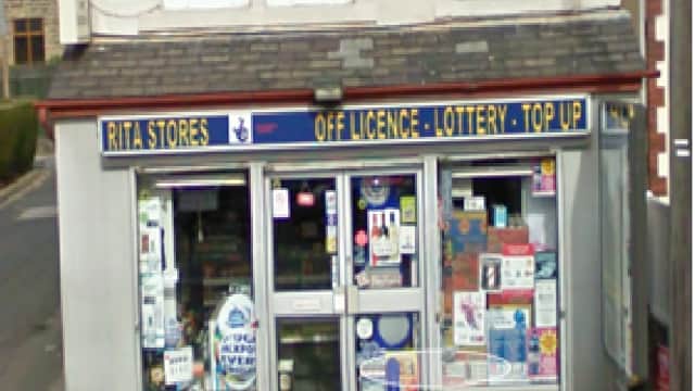 Shiv Stores storefront with signage for off-license, lottery, and top-up services in Riddlesden, Yorkshire.