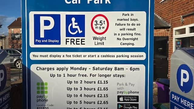 Sign for Barley Hill Road Car Park in Garforth, listing parking fees, hours, and payment options.