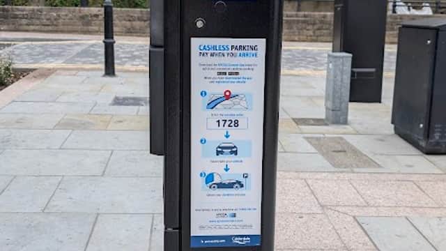 Pay & Display parking machine at 50 Tuel Ln, Sowerby Bridge, with instructions and a nearby can on the ground.