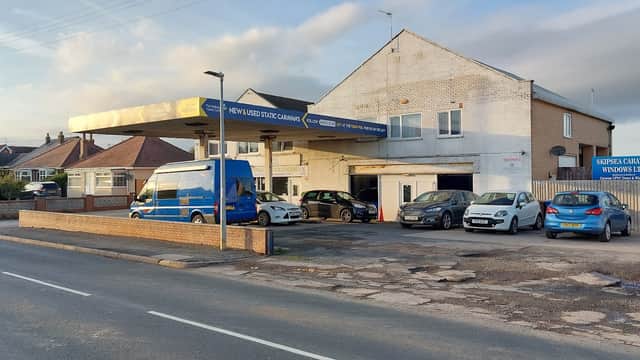 Skipsea Service Station Ltd with several cars parked outside, located on a quiet street in Skipsea, Yorkshire.