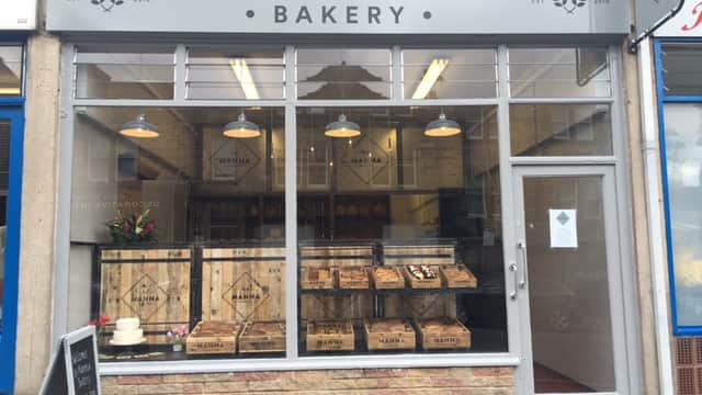 Charming bakery storefront with wooden crates, a cake display, and a sign reading "Manna Bakery" in Harrogate, Yorkshire.