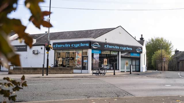 Chevin Cycles storefront in Otley, featuring large windows, signage, and a bicycle parked outside.