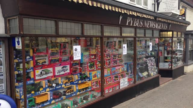 Colorful display of toys and books in the window of Pybus Newsagents in Boroughbridge, Yorkshire.