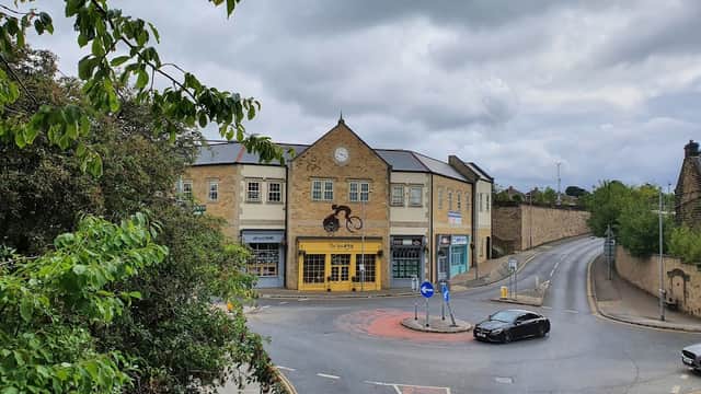 The Spa 493 building with a clock, surrounded by trees, near a roundabout in Penistone, Yorkshire.