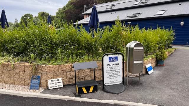 Platform 3 Car Park with signage, pay station, hedges, and umbrellas in a landscaped area in Pickering, Yorkshire.