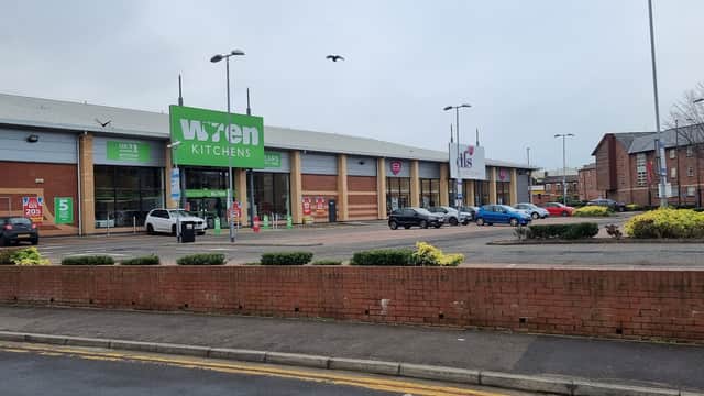 Exterior view of DFS Sheffield, featuring Wren Kitchens, with parked cars and landscaped areas.