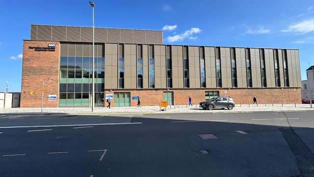 Modern brick building with large windows, on-street parking, and clear blue sky in Tees Valley, Yorkshire.