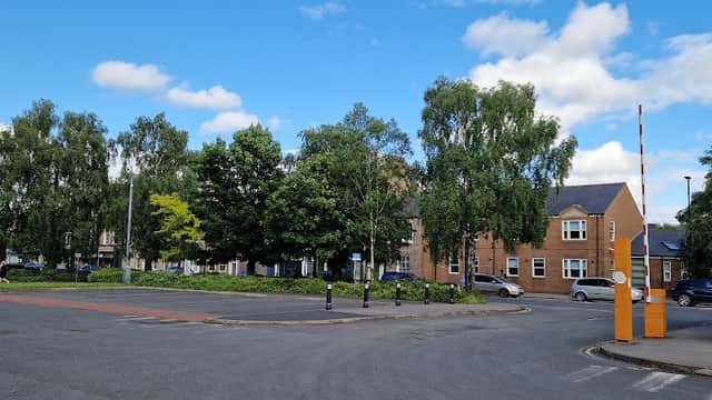 Union Terrace Car Park featuring trees, blue sky, and surrounding buildings with a barrier at the entrance.