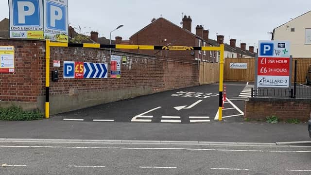Entrance to Mallard 2 Car Park with pay signs, marked lanes, and brick wall backdrop in Doncaster, Yorkshire.