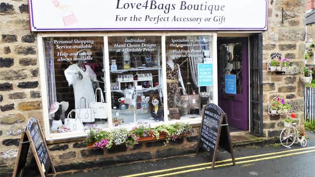 Jewellery boutique storefront with a variety of accessories, flower displays, and chalkboard signs in Otley, Yorkshire.