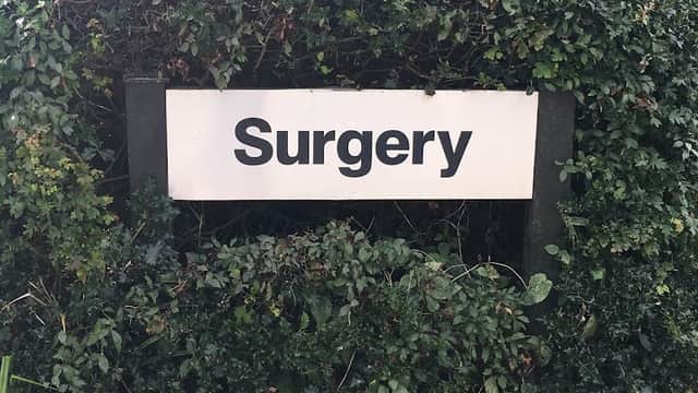 Sign reading "Surgery" surrounded by lush greenery at Ayton & Snainton Medical Practice in East Ayton, Yorkshire.