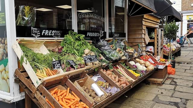 Colorful display of fresh vegetables and produce outside The Greengrocer shop in Thirsk, Yorkshire.