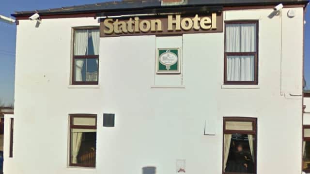 White building with "Station Hotel" sign, large windows, and a clear blue sky in Patrington, Yorkshire.