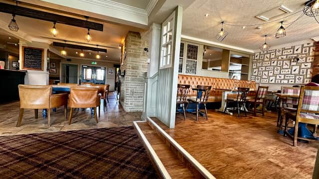 Cozy restaurant interior with wooden flooring, leather seating, and decorative wall art in Low Worsall, Yorkshire.