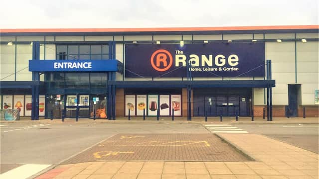 Storefront of The Range in Leeds, featuring a large sign, entrance, and parking area.