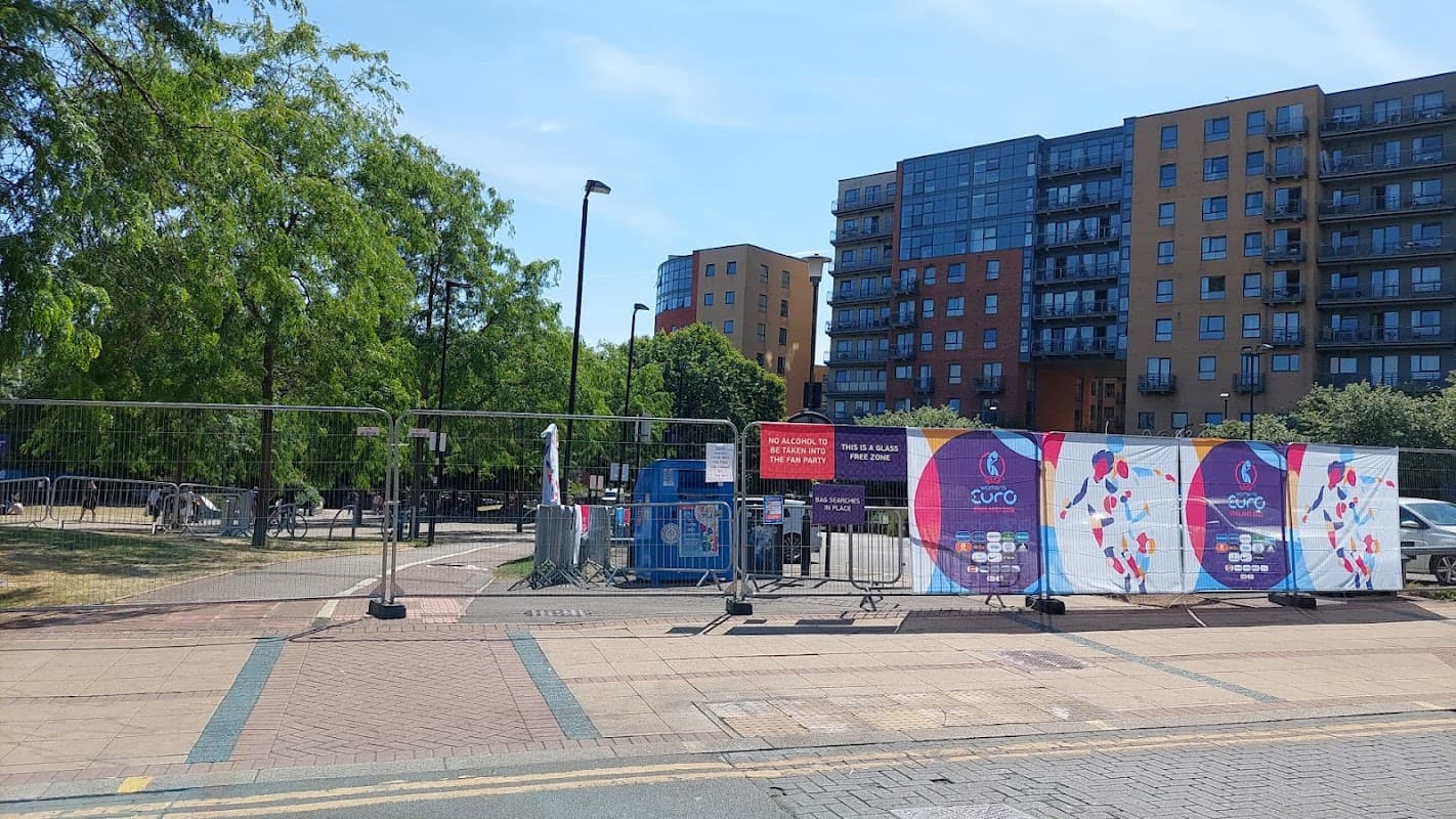 Fitzwilliam Street Car Park entrance with barriers, signage, and nearby modern apartment buildings under clear blue sky.