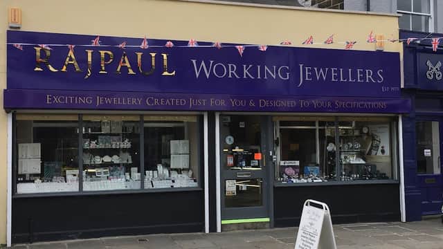 Storefront of Rajpaul Working Jewellers in Leeds, featuring a purple sign and various jewelry displays.