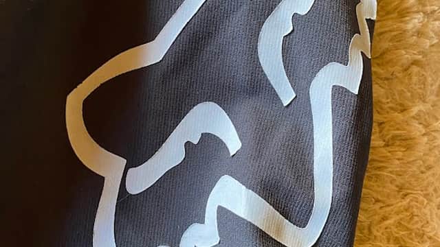 Black fabric featuring a large white fox logo, possibly related to mountain biking or outdoor sports.