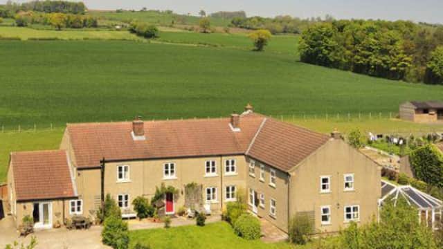 Elmfield House, a spacious guest house with a garden, surrounded by lush green fields and trees in Yorkshire.
