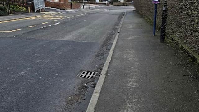 Street view of Park Drive Way/Paterson Close, featuring a quiet road, residential buildings, and a bus stop.