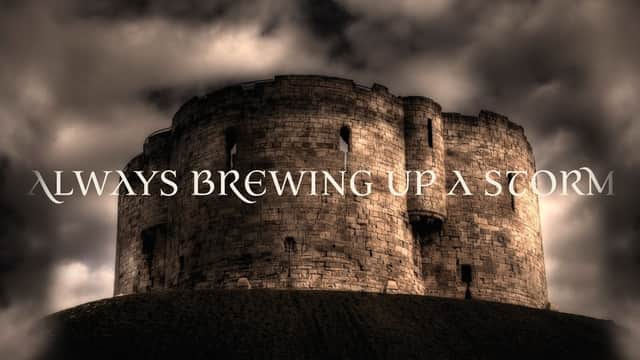 Historic stone tower with dramatic clouds, featuring the text "Always Brewing Up a Storm."