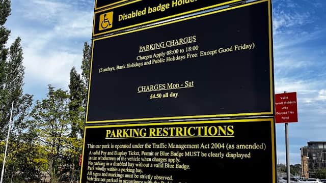 Sign for Waterfront Car Park in Wakefield, detailing parking charges, hours, and restrictions for disabled badge holders.