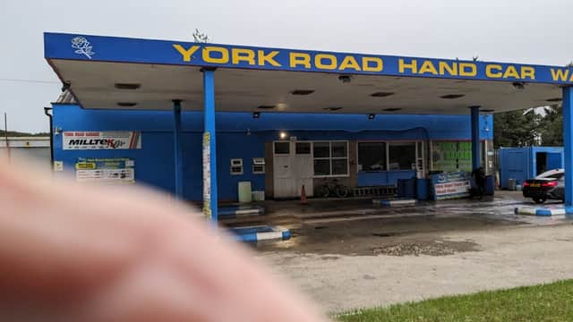 York Road Garage with blue exterior, signage, and a car wash area, located in Wilberfoss, Yorkshire.