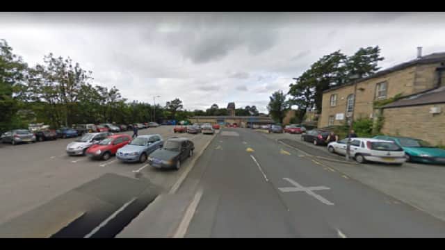 Pay & Display parking area in Norristhorpe, Yorkshire, with various parked cars and a cloudy sky.