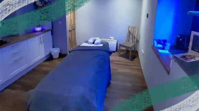 Serene therapy room with a massage table, soft lighting, and calming decor in Goodwood Beauty & Holistic Therapies.